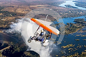 Tourists fly over the Victoria Falls on the trikes.